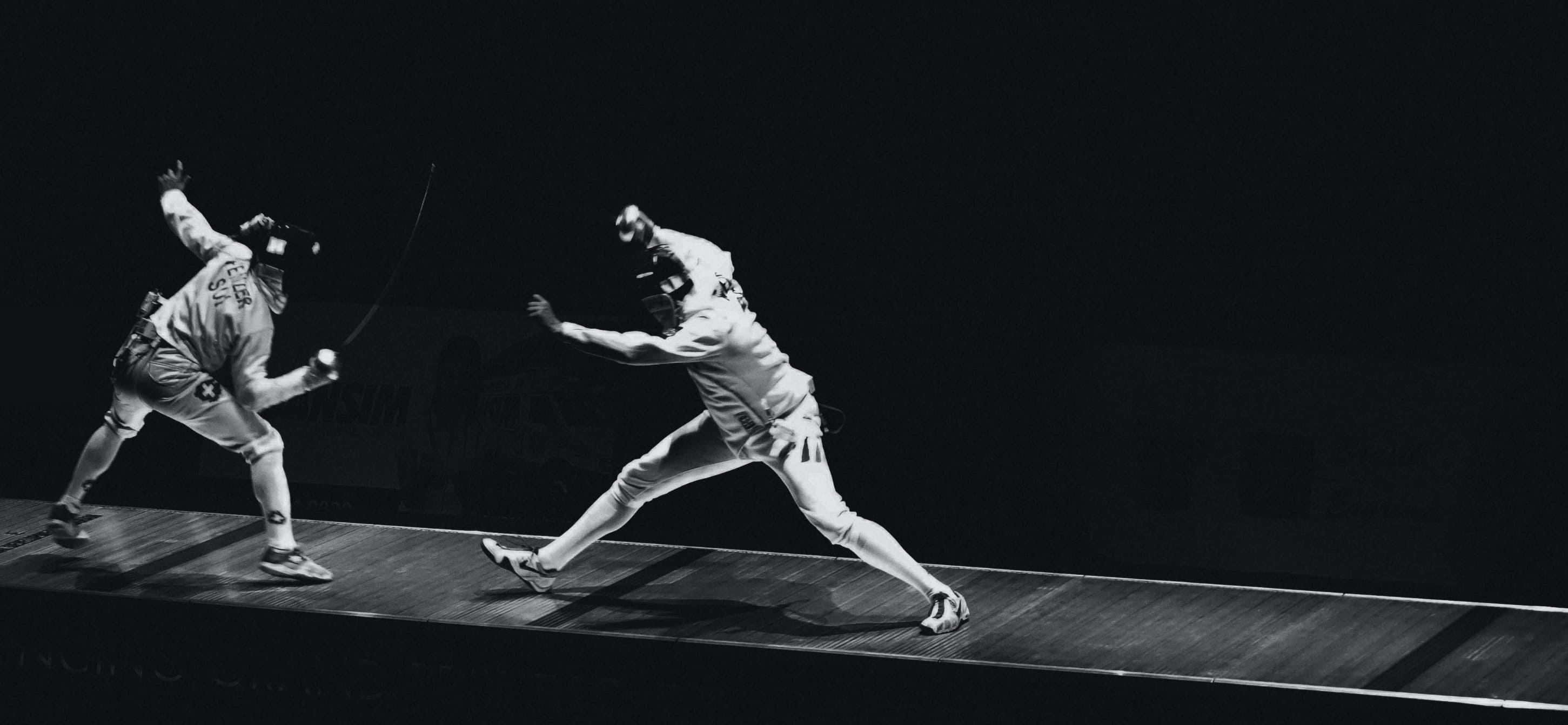 Two fencers in the middle of a sparing duel